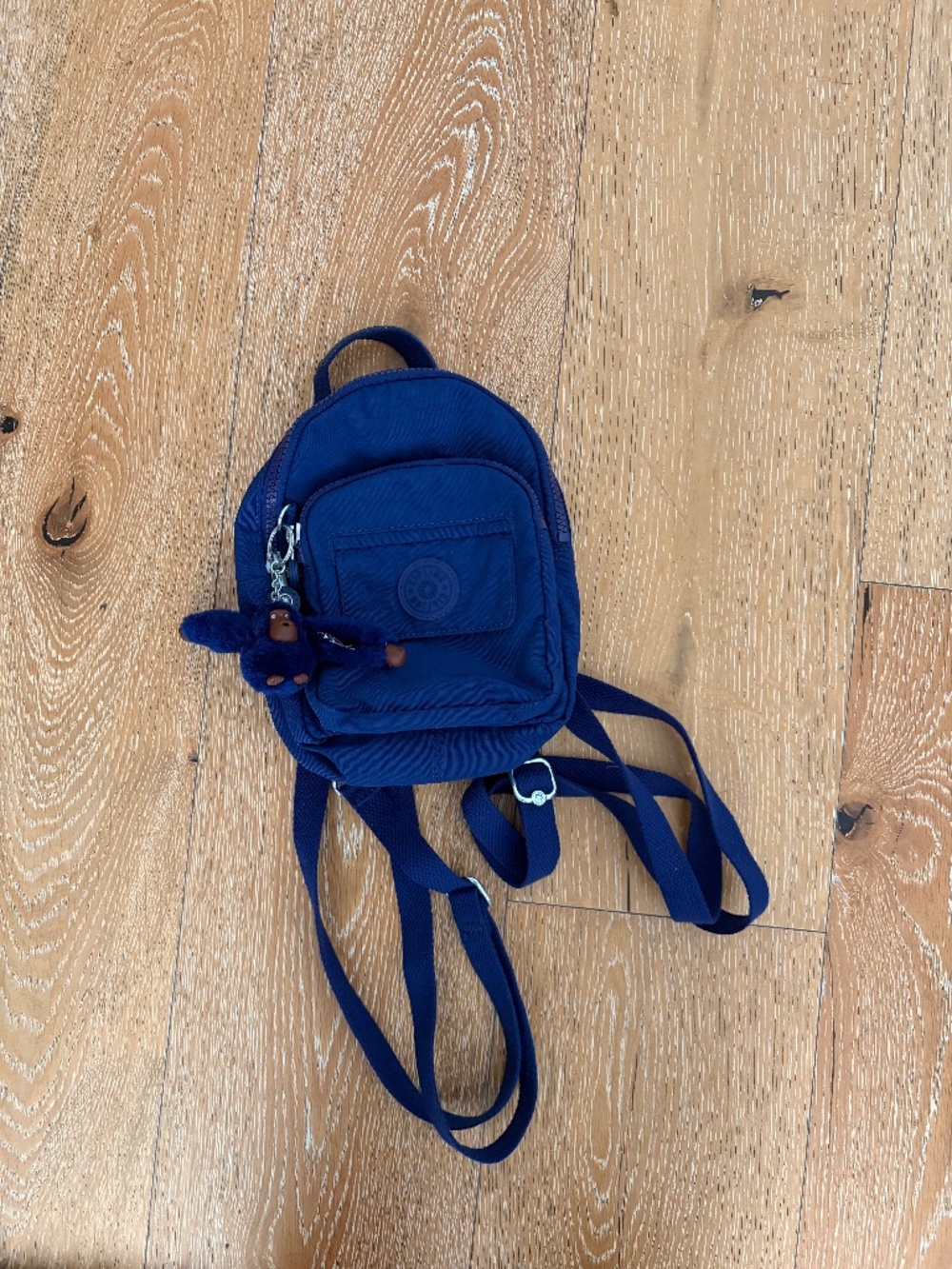 Purple Kipling mini backpack with monkey keychain
